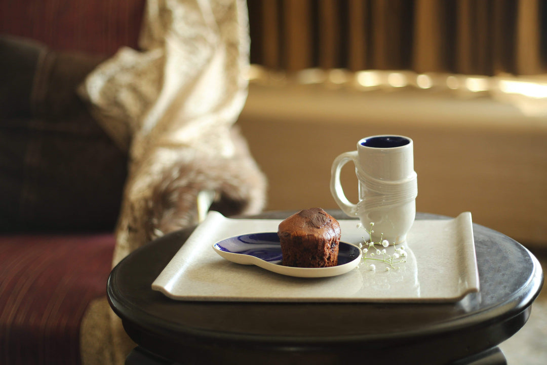 Ware Innovations Mumbai Marble Serving Tray With a ceramic plate and Coffee Mug placed on it 